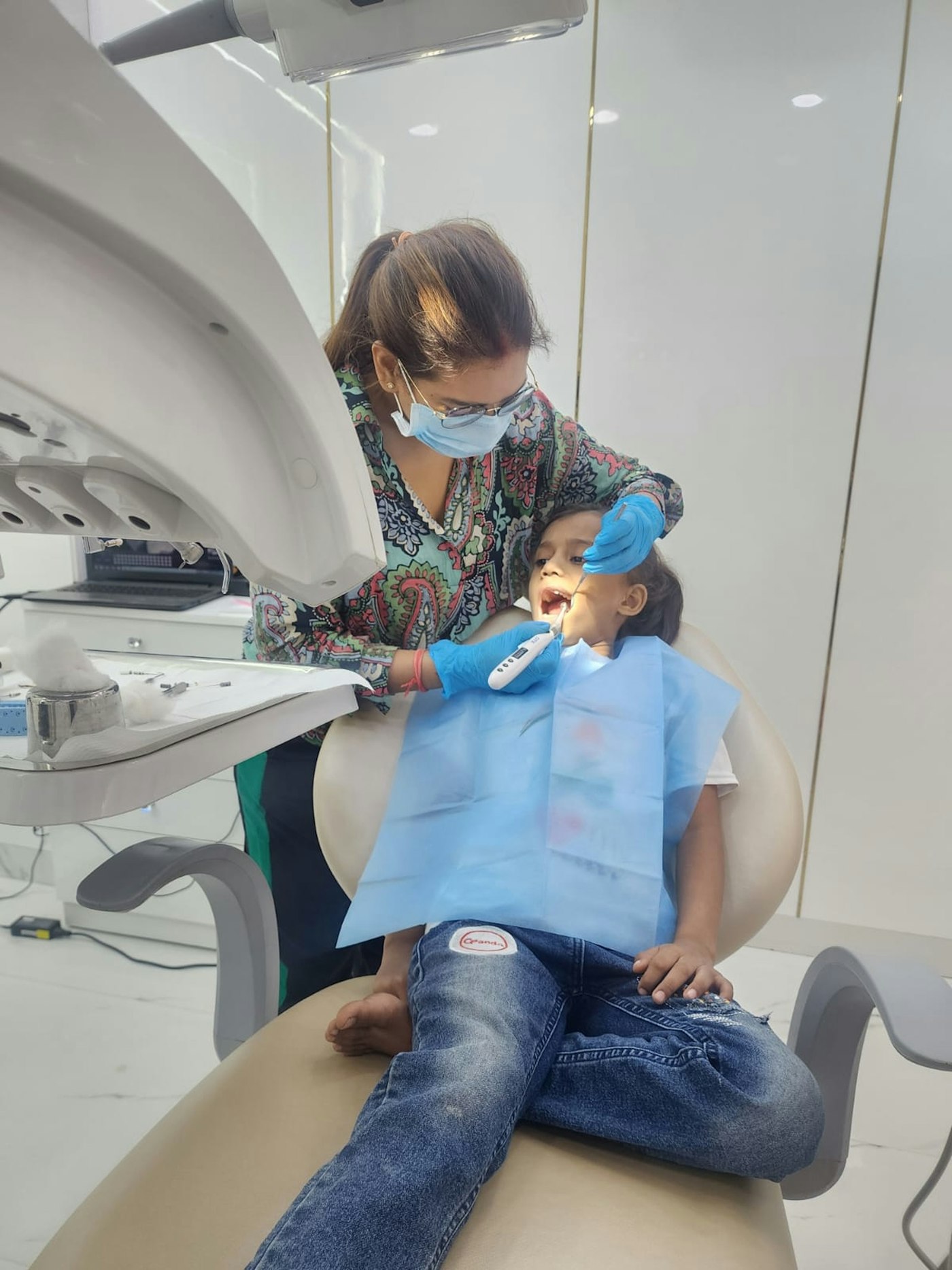 A young boy having his teeth checked at a dental clinic in Lucknow