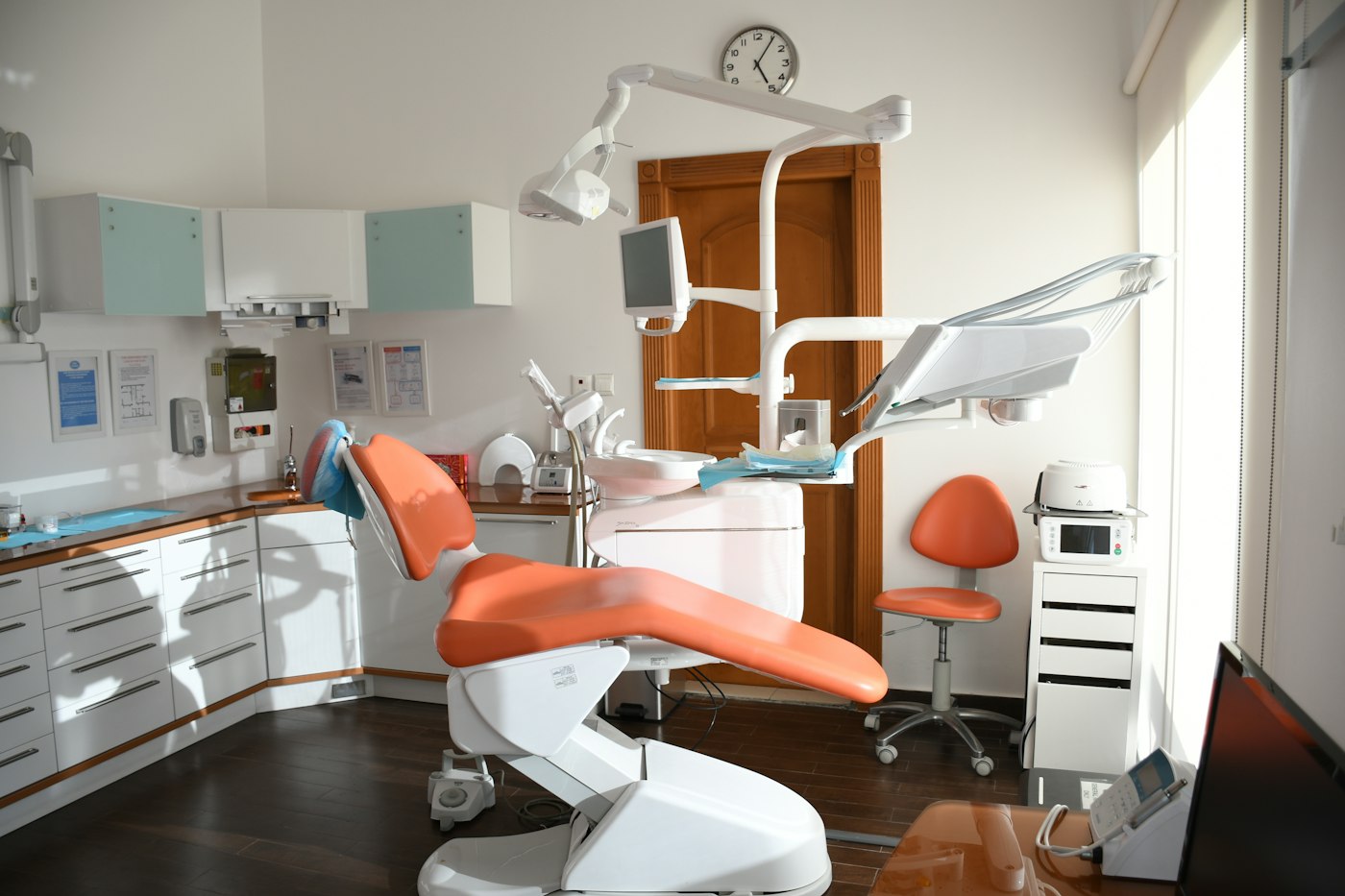 A dental chair in a bright clinical office